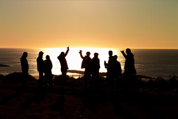 Fototapeta na wymiar silhouettes of people on the beach