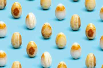 Yellow stone texture Easter eggs. Minimal style composition, Spring celebration concept. Modern pattern.