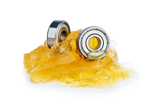 Ball bearing with yellow grease isolated on white background