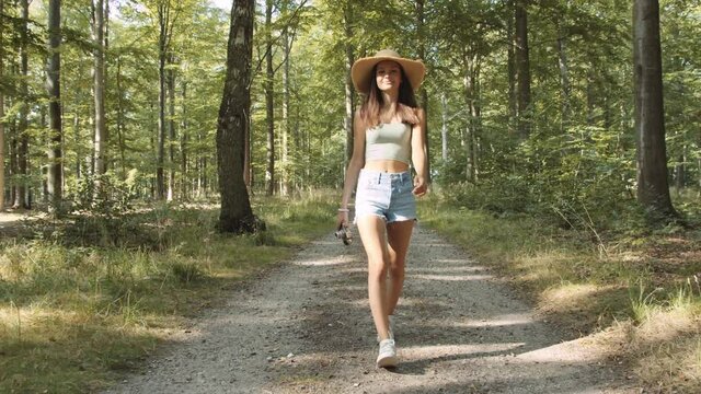Teenage Girl Walking Along Forest Path