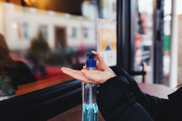 Using of sanitizer before entering the cafe. Blurred background