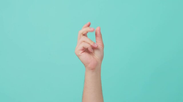 Close-up shot of human hand raising, with finger snapping gesture.