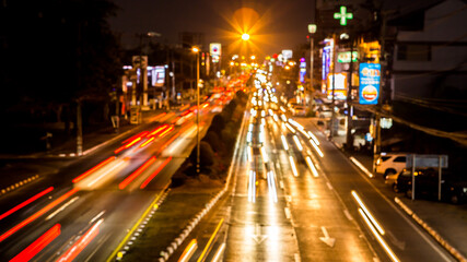 Fototapeta na wymiar Blurred traffic at night in downtown Chiangmai Thailand