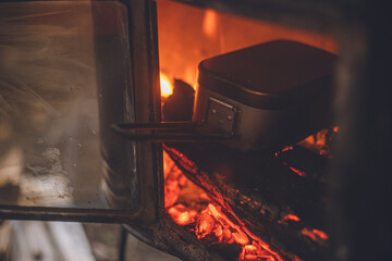 冬のキャンプ。野外で薪ストーブのアウトドア料理。