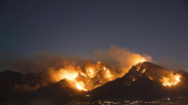 Night Timelapse of Massive Wildfire and Moonrise Above Urban City Area of Tucson Arizona USA. Out of Control Fire on Santa Catalina Mountains