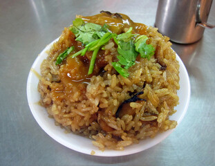 Taiwanese sticky rice, oil rice, youfan mixed with glutinous rice; pork; soy sauce or oyster sauce. traditionally served as a celebration when there is a newborn in the family.