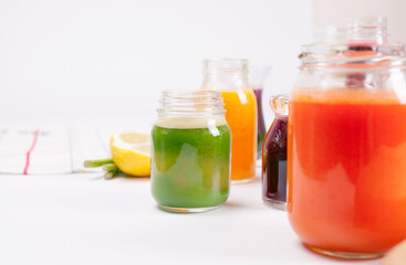 Glasses of fresh fruit juice isolated on white background