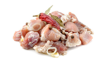 Raw pieces of pork shish kebab in marinade with pepper, onion,bay leaf, ready to cook, barbecue meat, isolated on a white background.
