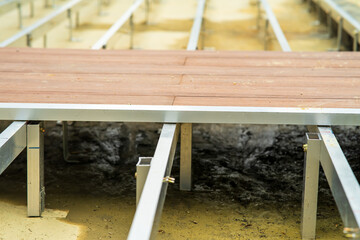 Installing wooden floor platform in a construction site.