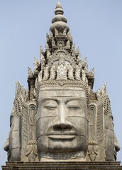 Buddha Statue Face and Ancient Khmer Architecture at Entrance Gate to Sangke Pagoda Budhhist Temple in Battambang, Cambodia