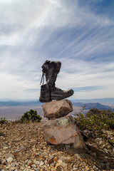 Pair of shoes on a rock on top of a hill