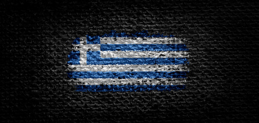 National flag of the Greece on dark fabric