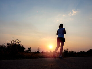 Fototapeta premium Woman running alone at beautiful sunset.