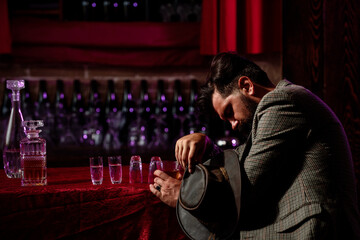 Alcoholism, alcohol addiction and people concept - man alcoholic with glass of whiskey and bottle...