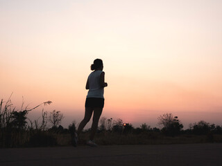 Woman running alone at beautiful sunset.