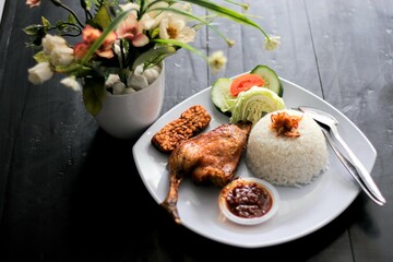 Photos of delicious and healthy fried chicken, chili sauce, and fresh vegetable