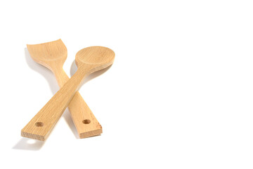 Cooking wooden spoon and spatula on white insulated background.Selective focus.