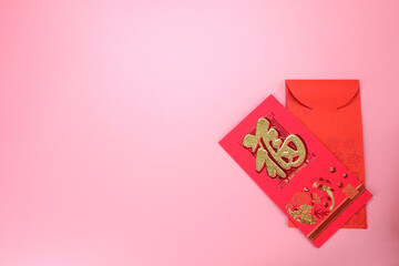 Red envelop for Chinese New Year isolated on pink background Chinese sentence mean "Happiness" and "All wishes come true"