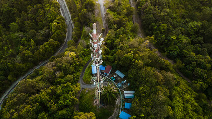 5G com towel from aerial view during sunrise and beautiful green forest.