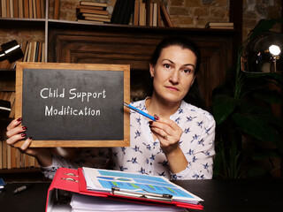 chalkboard in a hand with phrase Child Support Modification . Horizontal shot. Close-up