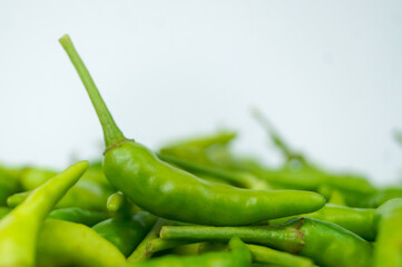 Green Thai chile peppers vary in size and shape, depending on the specific variety, and are generally small, conical, and slender, tapering to a point on the non-stem end.