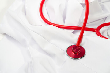 Red stethoscope on white background, close up