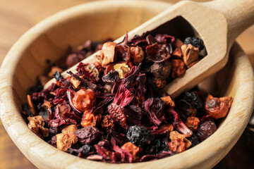 Scoop with dry fruit tea in bowl