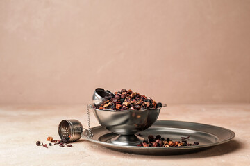 Fototapeta na wymiar Bowl with dry fruit tea on light background