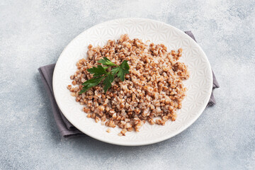 Boiled buckwheat on a plate. Healthy porridge enriched with vitamins. copy space, top view.