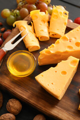 Composition with pieces of tasty cheese and honey on wooden background