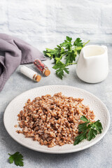 Boiled buckwheat on a plate. Healthy porridge enriched with vitamins. copy space,