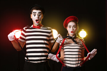 Male and female pantomimists on dark background - obrazy, fototapety, plakaty