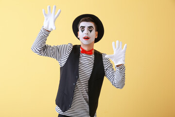 Male pantomimist on color background