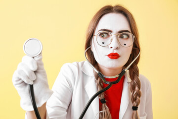 Female pantomimist dressed as doctor on color background