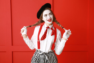 Female pantomimist on color background