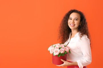 African-American woman with flowers on color background. Valentine's Day celebration
