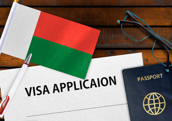 Flag of Madagascar, visa application form and passport on table