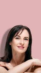 Fototapeta premium Mature woman with perfect skin on pink background, image designed for smartphone