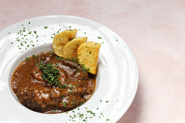 Homemade stew of osso buco meat with aromatic herb sauce