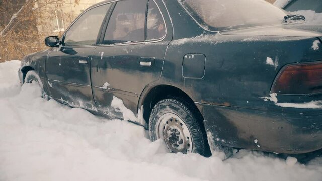 Passenger car stuck in a snowdrift, wheel slip
