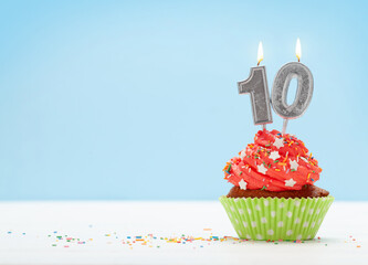 Birthday cupcake with burning candles