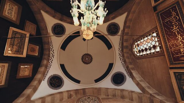Entrance of Konya Mevlana Tomb, Arabic inscriptions on the wall and ceiling.  Ottoman mosque ceiling. 4K.
