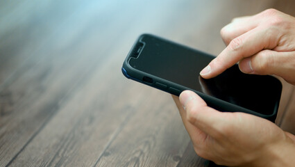 スマートフォンを操作する男性の手