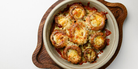 Stuffed mushrooms with parmesan cheese inside. Delicious baked mushrooms served in a ceramic bowl...
