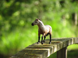 toy horse on the fence