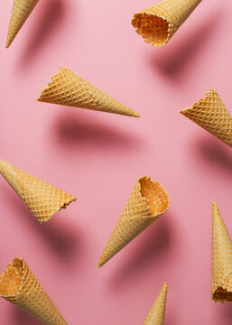 Ice cream cones levitate over pink, pattern background