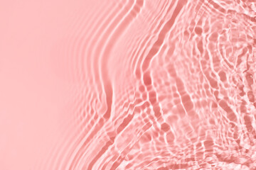 Transparent and clean pink water background with sunlight reflection