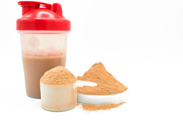 Whey protein powder on white background. Plastic measuring dietary spoon and bottle shake of chocolate food drink. Sport workout gym nutrition energy replacement. Exercise muscle body fitness training