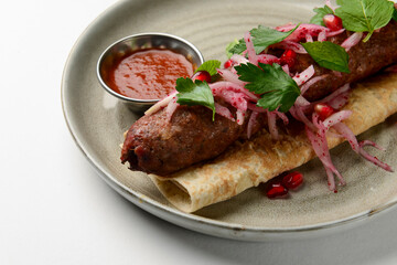 Tasty lavash rolls with sausages and vegetables, isolated on white. Georgian cuisine concept.