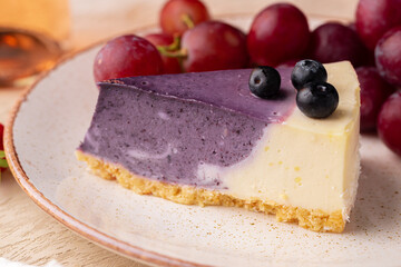Blueberry cheesecake served on plate with grapes